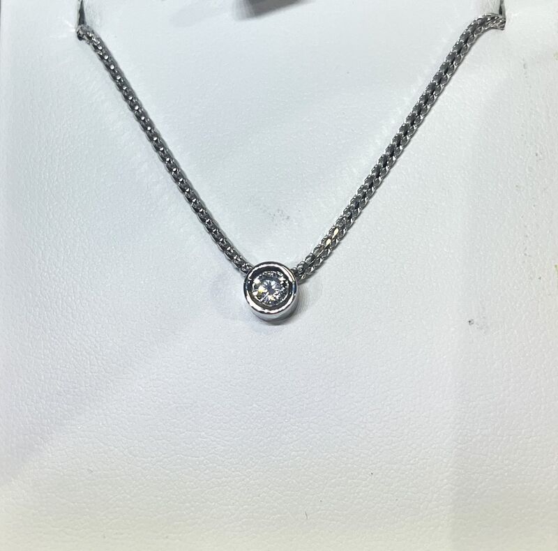 A diamond pendant on a fine white gold chain