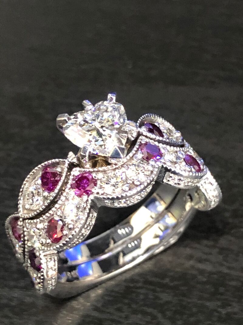 A floral cluster ring set with pink and purple stones and diamonds