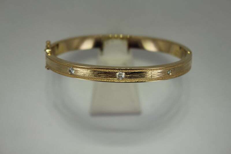 A yellow gold band with channel-set diamonds