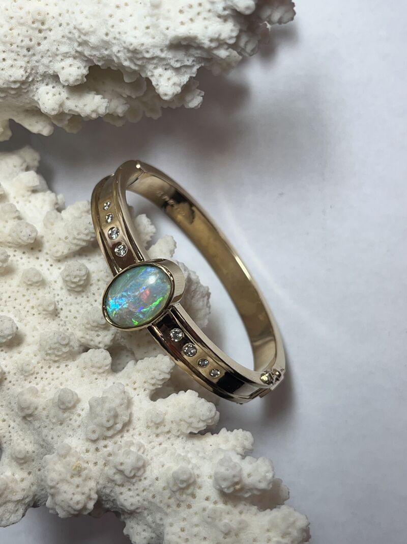 A gold ring with a baguette-cut centre stone