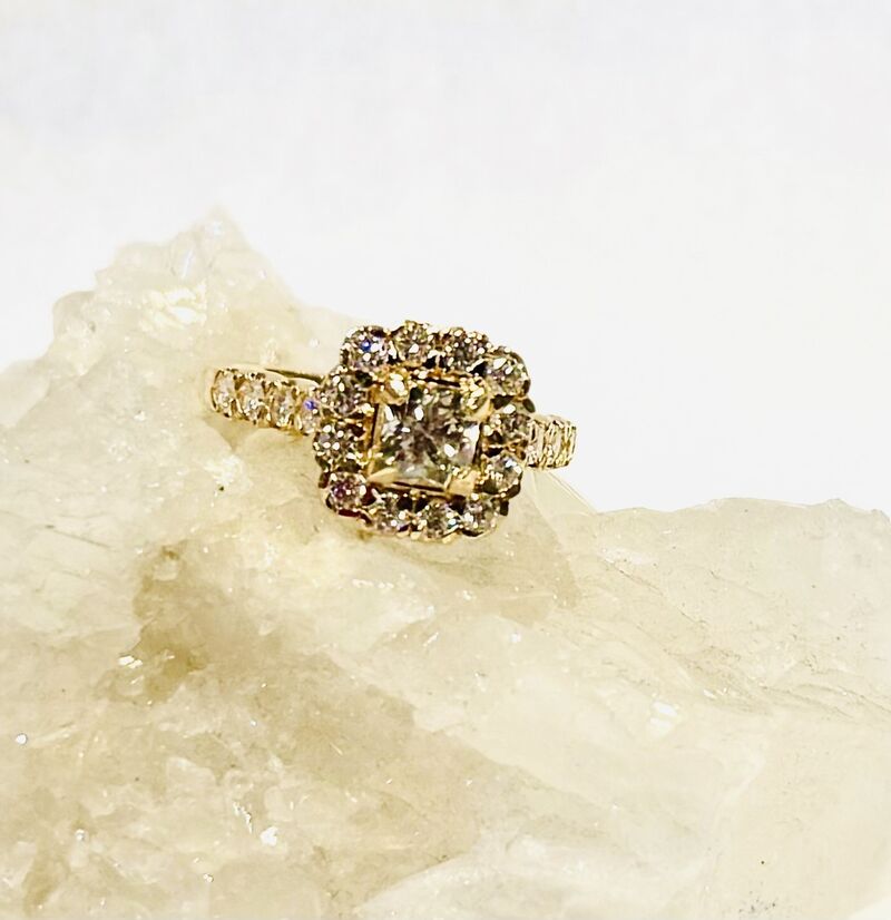 A gold ring resting on a raw quartz crystal