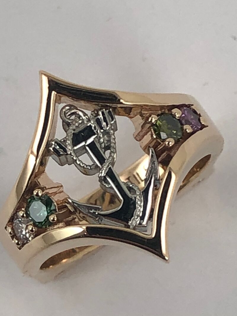 A custom ring with engraved leaf motifs and inlaid gold