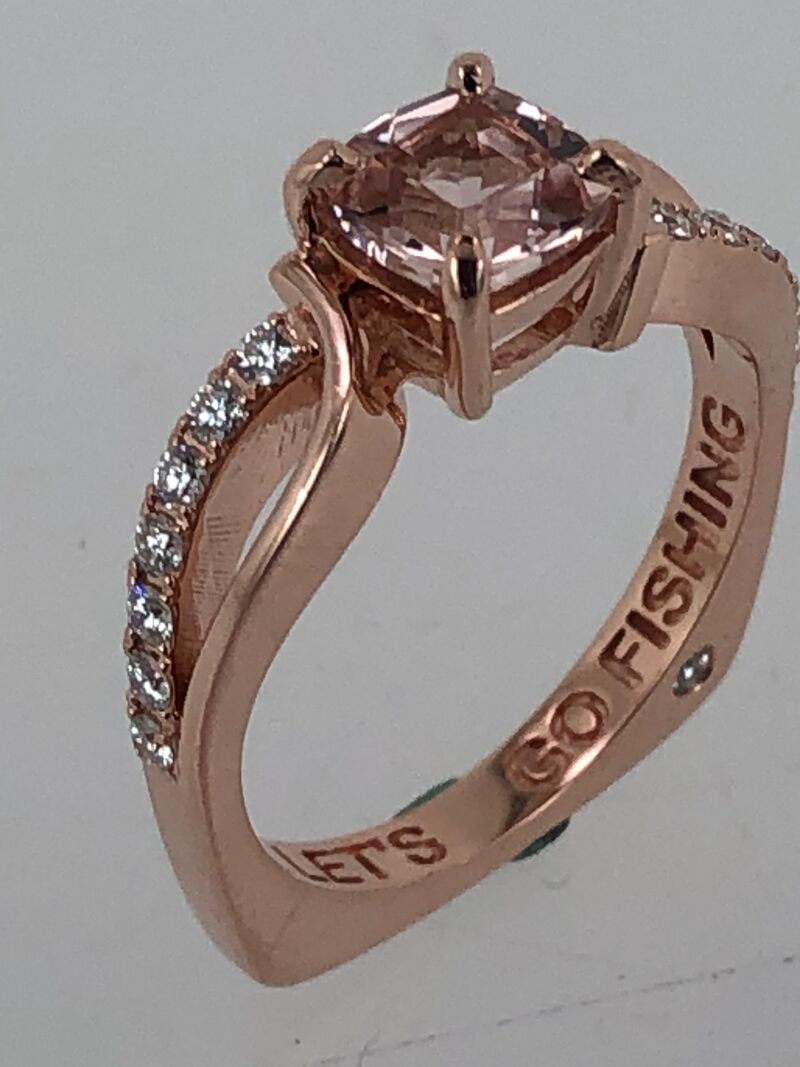 A rose gold engagement ring with a hand-engraved band
