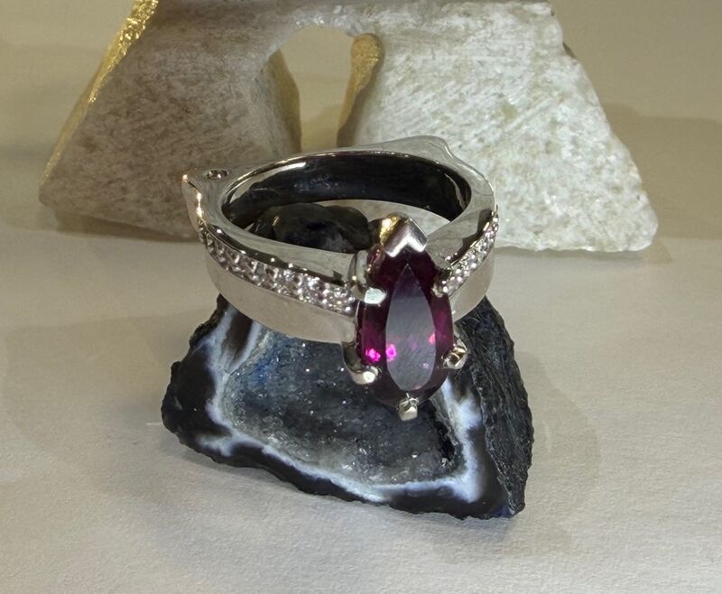 A custom rubellite garnet ring in white gold with diamond detail