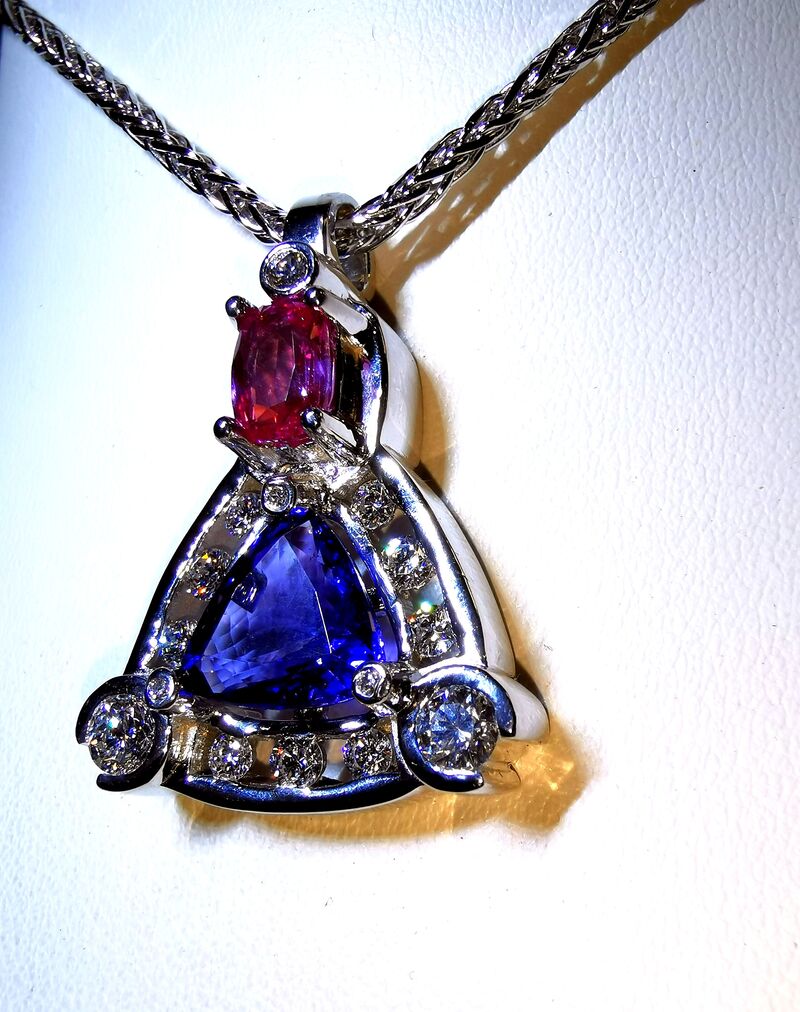 A tanzanite and ruby pendant on a white gold chain
