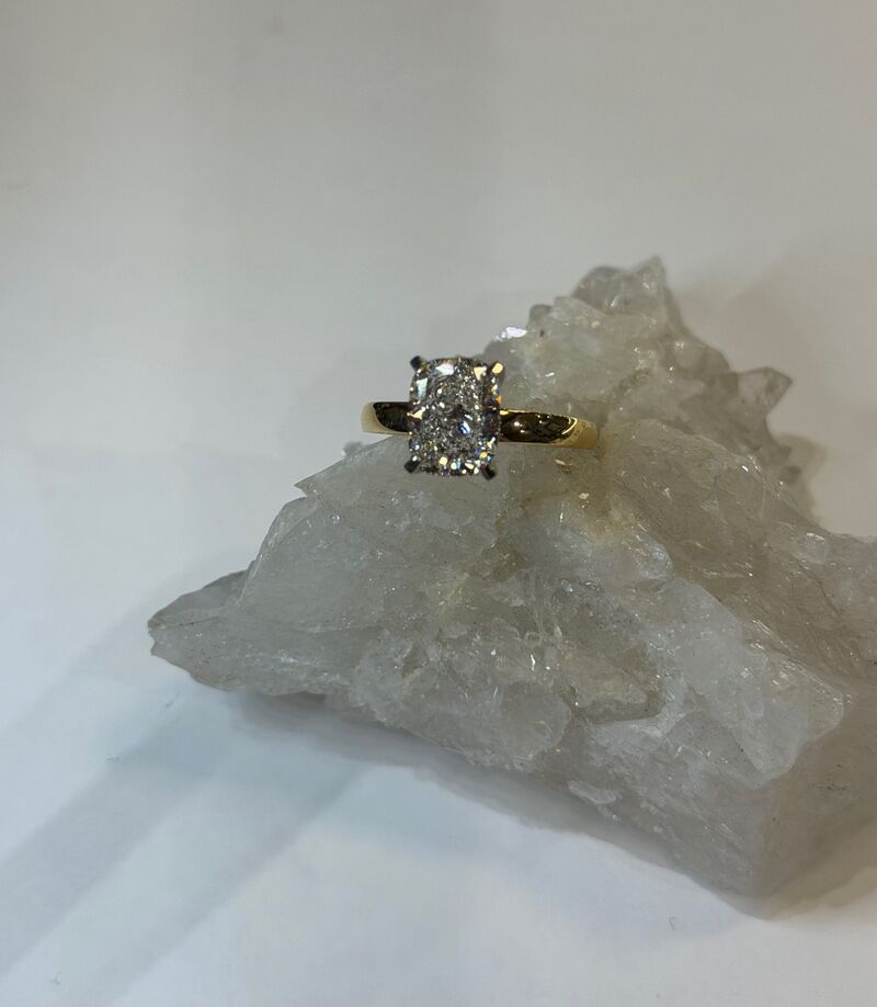 A textured gold ring with diamond detail