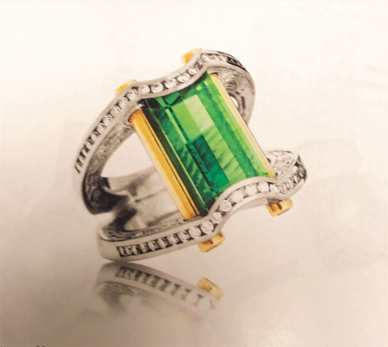 An emerald-cut green tourmaline ring set in white gold
